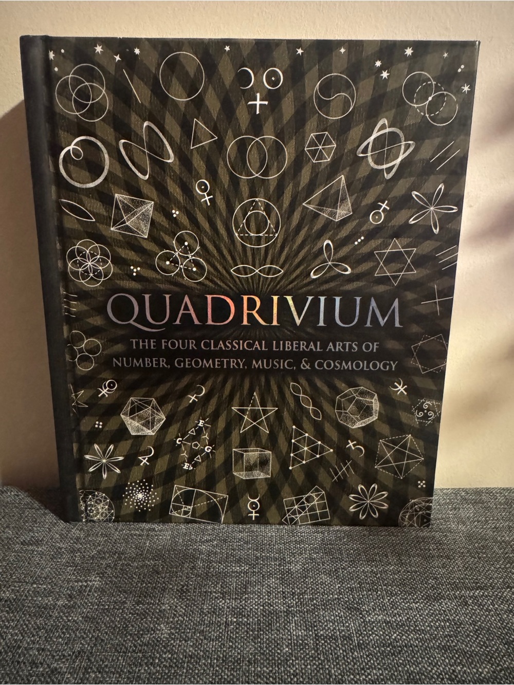 Quadrivium Hardcover Book - Black Cover with holographic letters.
